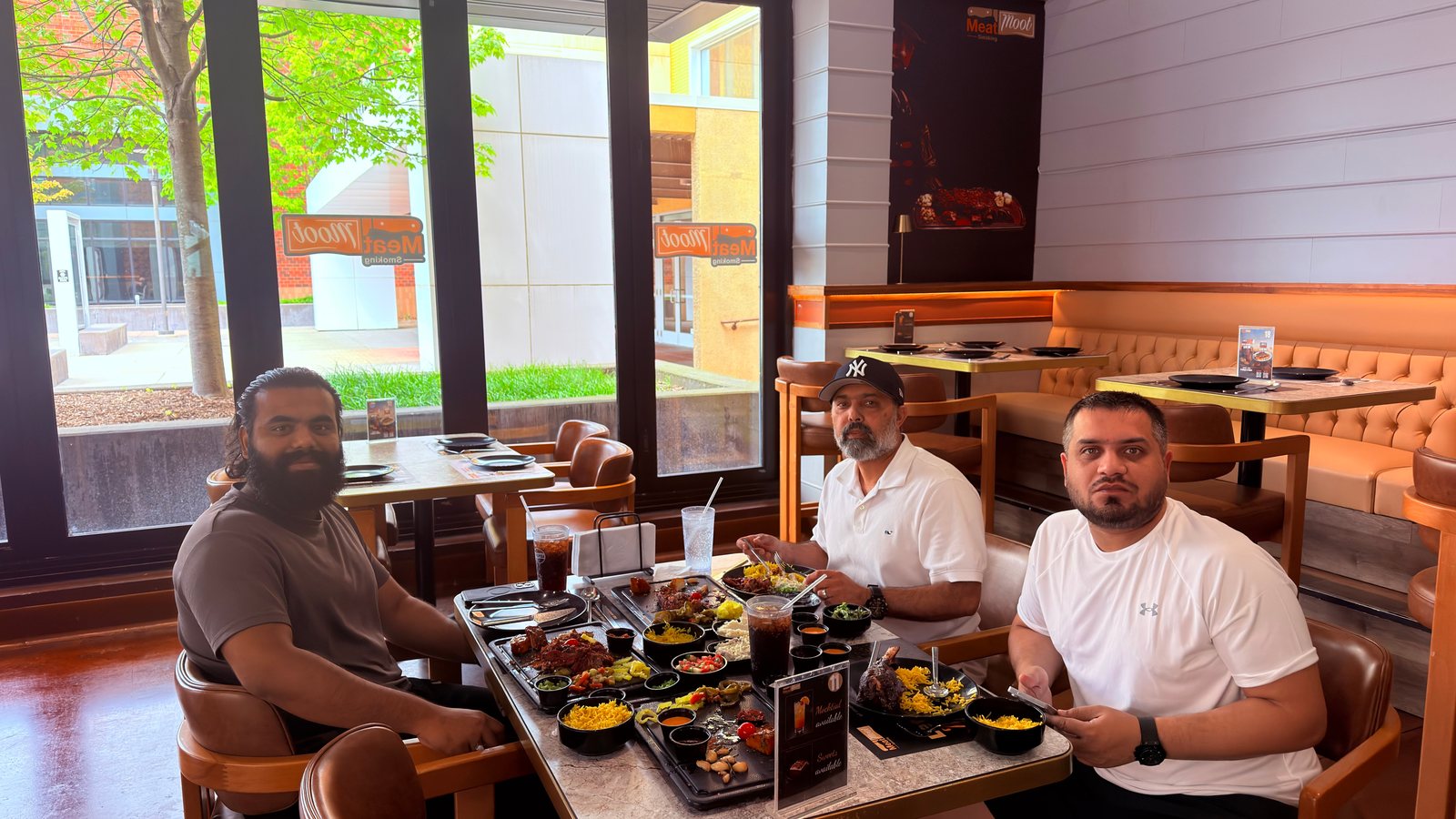 Wali Zuberi sharing a meal with two others at a restaurant