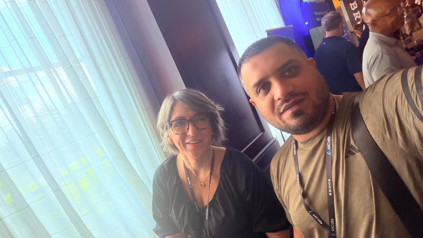 Wali Zuberi taking a selfie with a fellow attendee by a window at MedicareCon 2026 in Hoover, Alabama
